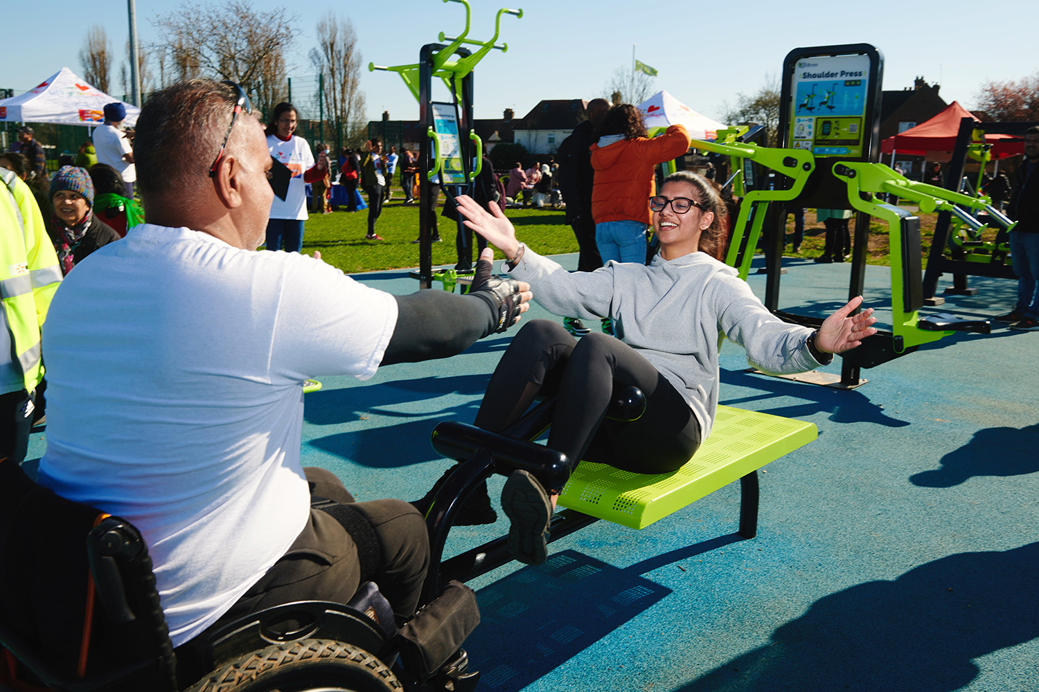 two people exercising on gym equipment 